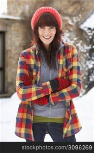 Woman In Snowy Landscape Wearing Warm Clothing