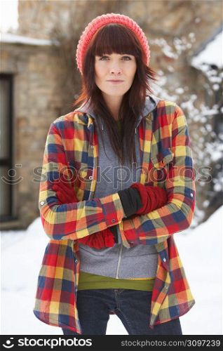 Woman In Snowy Landscape Wearing Warm Clothing