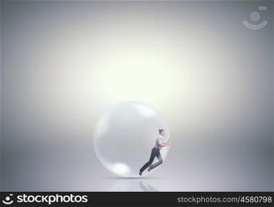 Woman in soap bubble. Young businesswoman trying to get out of soap bubble
