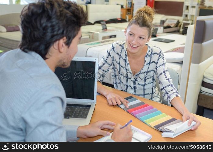 Woman in soft furnishings store choosing color scheme