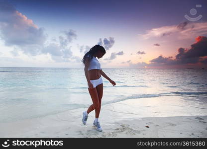 Woman in sportswear on beach