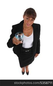Woman in suit holding glass of water