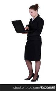 Woman in suit using laptop