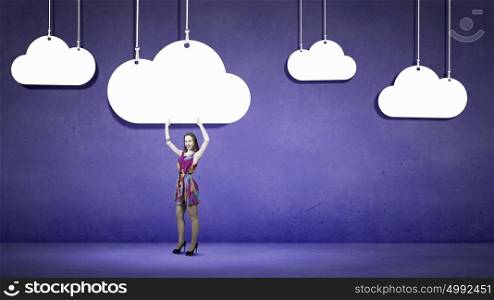 Woman in summer dress. Young girl in multicolored bright dress and clouds hanging above
