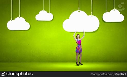 Woman in summer dress. Young girl in multicolored bright dress and clouds hanging above