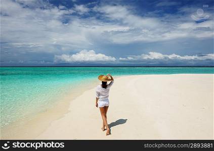 Woman in sun hat at tropical beach