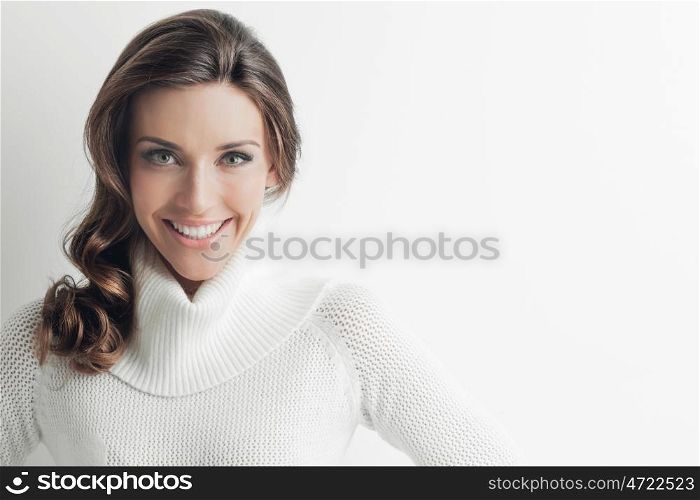 Woman in sweater. Studio portrait of beautiful long-haired woman in hot sweater on white background
