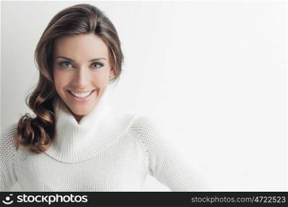 Woman in sweater. Studio portrait of beautiful long-haired woman in hot sweater on white background