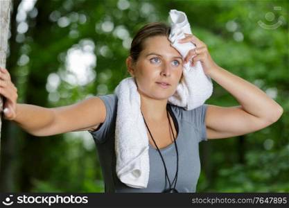 woman in the forest with a towel after working out