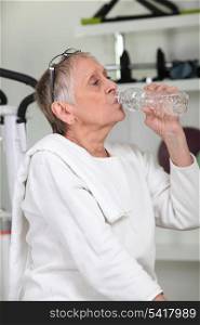Woman in the gym drinking water