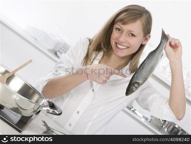 woman in the kitchen with fish in hand