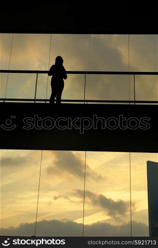 woman in the modern buildind at sunset