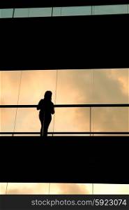 woman in the modern buildind at sunset