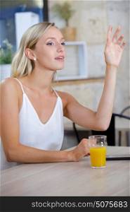 woman in the restaurant waving at someone