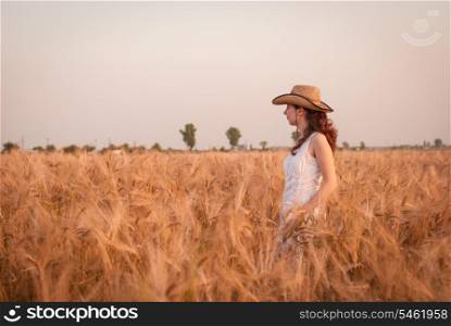 Woman in the wheat field, farmer with crop