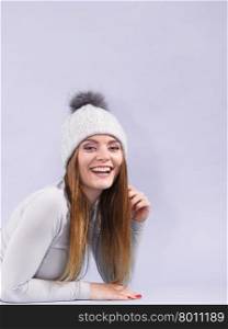 woman in thermal underwear. Attractive woman in winter cap and gray sports thermolinen underwear for skiing training studio shot on violet. Long sleeves top