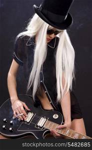 woman in top hat with black electric guitar and cigarette