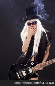 woman in top hat with black electric guitar and cigarette