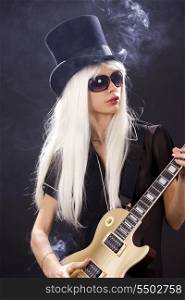 woman in top hat with golden electric guitar and cigarette