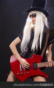 woman in top hat with red electric guitar and cigarette