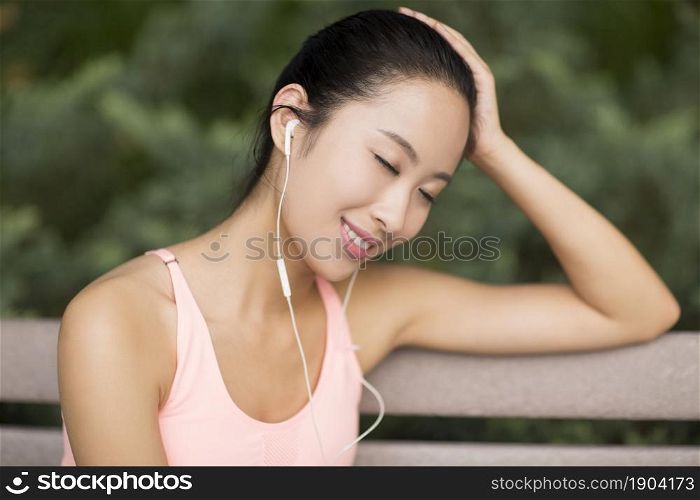 Woman in tracksuit listening to music