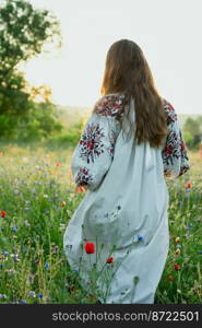 Woman in traditional dress scenic photography. Poppy field. Picture of lady with beautiful nature on background. High quality wallpaper. Photo concept for ads, travel blog, magazine, article. Woman in traditional dress scenic photography