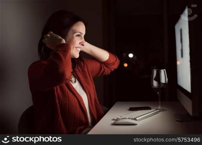 Woman in video call with a glass of wine on hand