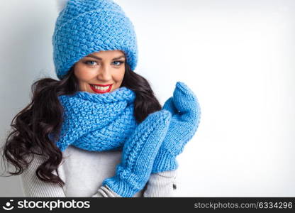 Woman in warm clothing. Beautiful woman in warm hat, mittens and scarf on white background