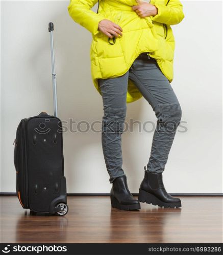 Woman in warm jacket with suitcase. Tourist travel girl. Tourism.
