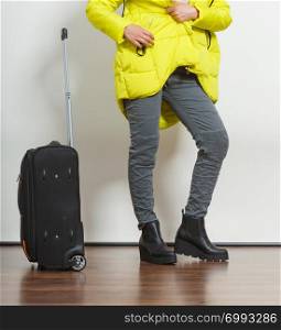 Woman in warm jacket with suitcase. Tourist travel girl. Tourism.