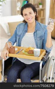woman in wheelchair having breakfast
