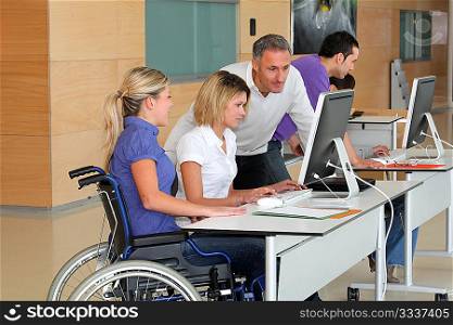 Woman in wheelchair working in the office