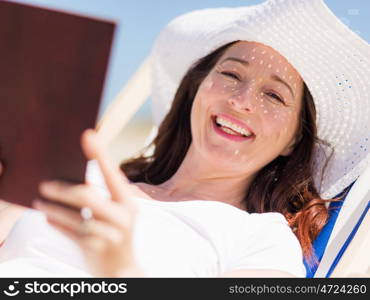 Woman in white clothes on the beach on sunny day. Beautiful day on the beach