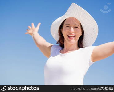 Woman in white clothes on the beach on sunny day. Beautiful day on the beach