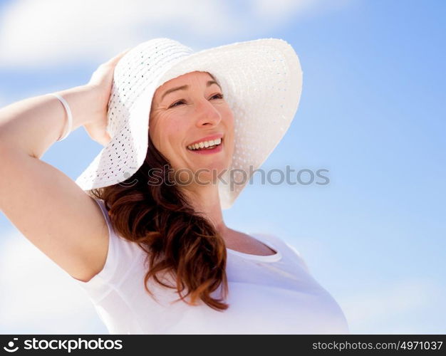 Woman in white clothes on the beach on sunny day. Beautiful day on the beach