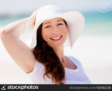 Woman in white clothes on the beach on sunny day. Beautiful day on the beach