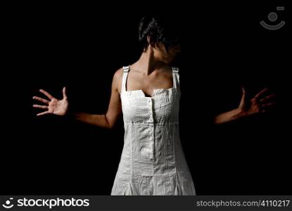 Woman in white dress with hands outstretched