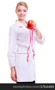 Woman in white lab coat recommending healthy food. Doctor dietitian holding fruit apple and measture tape isolated. Diet.