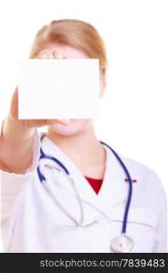 Woman in white lab coat recommending your product. Doctor or nurse with stethoscope holding blank copy space card isolated. Medical person for health insurance.