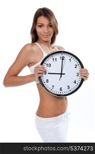 Woman in white underwear with a clock showing 9 o&rsquo;clock