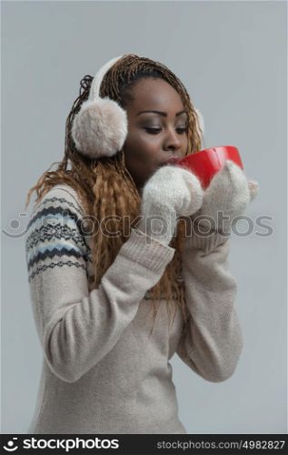Woman in winter clothes enjoying a hot drink