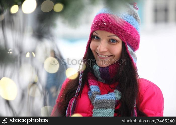 woman in winter hat and holyday bokeh