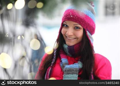 woman in winter hat and holyday bokeh
