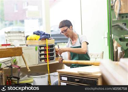 Woman in workshop making alphorn