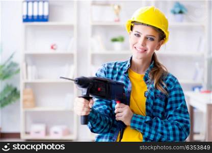 Woman in workshop with drilling drill