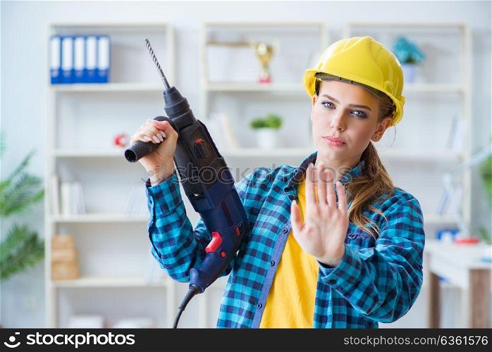 Woman in workshop with drilling drill. The woman in workshop with drilling drill