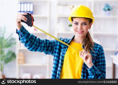 Woman in workshop with measuring tape