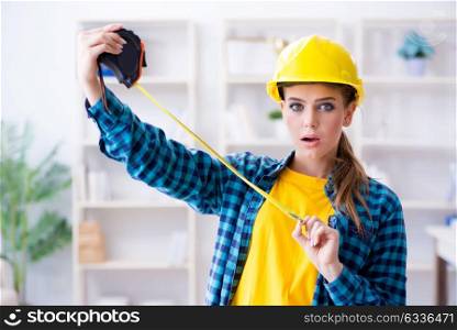 Woman in workshop with measuring tape. The woman in workshop with measuring tape