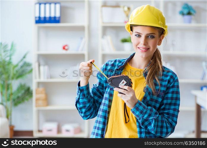 Woman in workshop with measuring tape. The woman in workshop with measuring tape