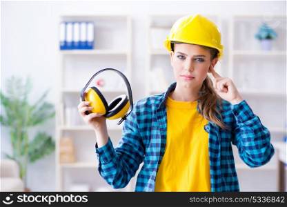 Woman in workshop with noise cancelling headphones